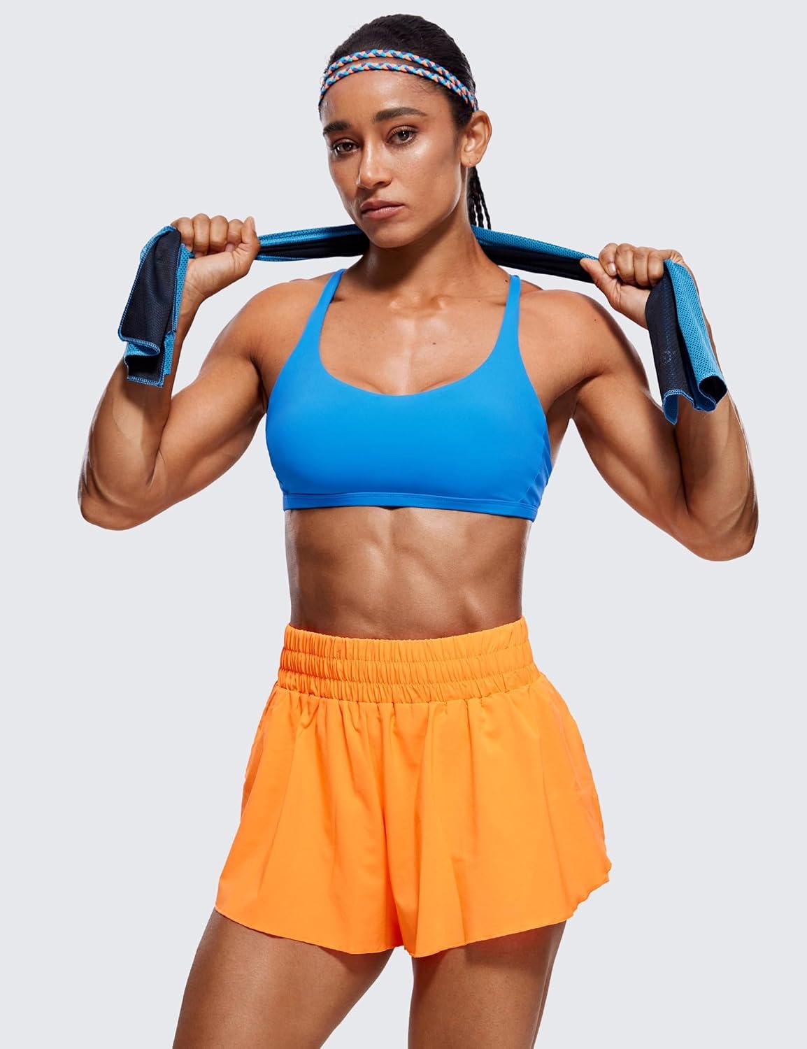 imageCRZ YOGA Womens Naked Feeling Criss Cross Sports Bra Strappy Back Padded Medium Support Wireless Gym Cami Workout YogaMadagascar Blue