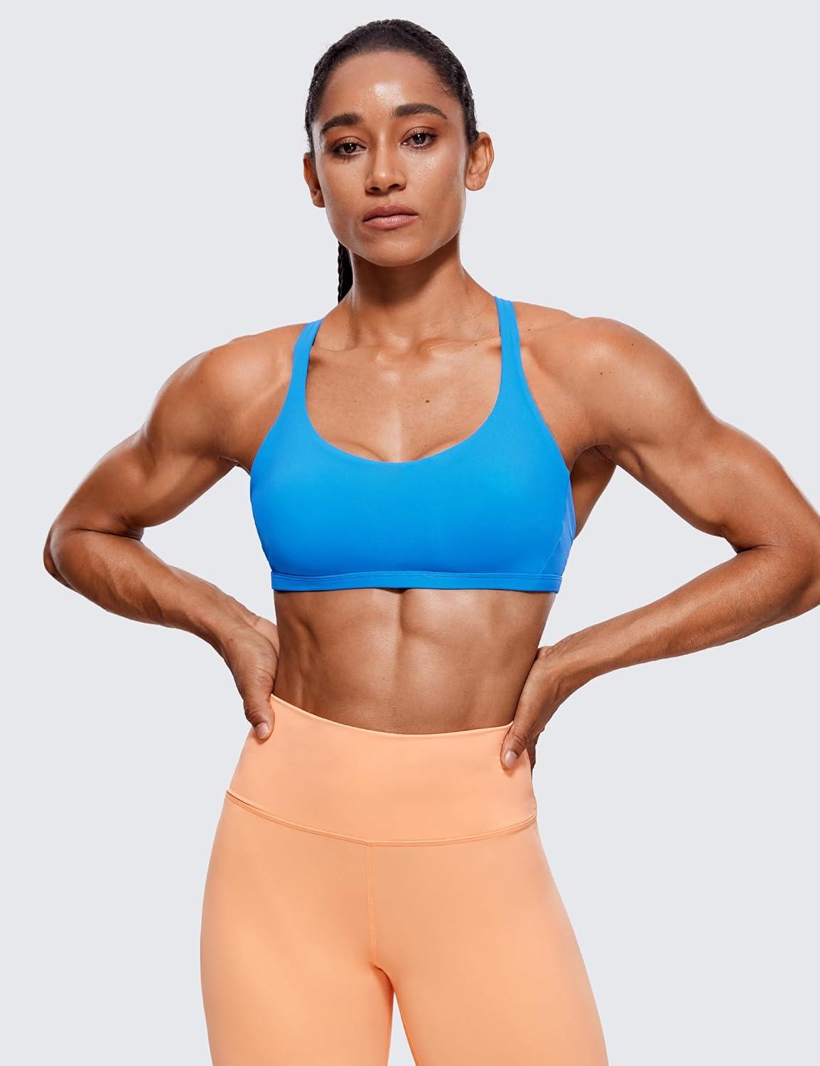 imageCRZ YOGA Womens Naked Feeling Criss Cross Sports Bra Strappy Back Padded Medium Support Wireless Gym Cami Workout YogaMadagascar Blue