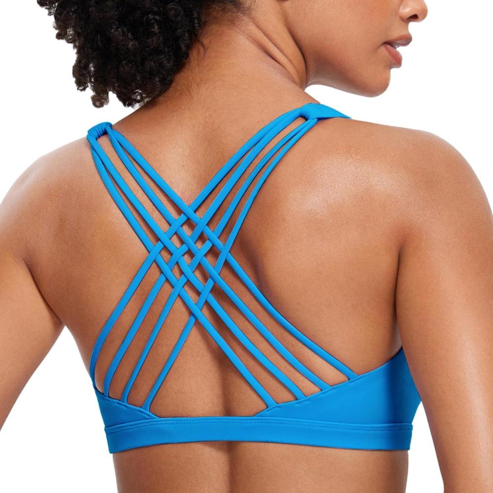 imageCRZ YOGA Naked Feeling Strappy Sports Bras for Women  Criss Cross Back Wireless Padded Cami Yoga Workout TopMadagascar Blue
