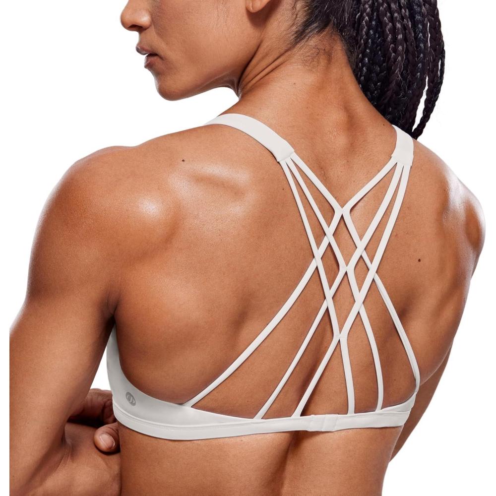 imageCRZ YOGA Womens Naked Feeling Criss Cross Sports Bra Strappy Back Padded Medium Support Wireless Gym Cami Workout YogaMilky White