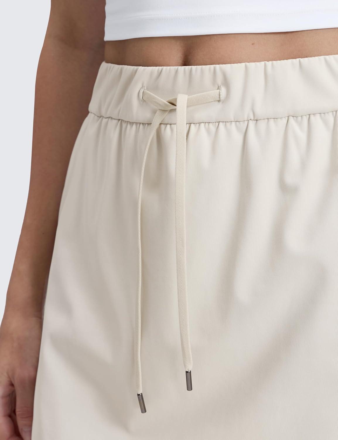 imageCRZ YOGA 4Way Stretch A Line Skirts for Women High Waitsted Mini Lined Tennis Work Drawstring Skort with PocketsMilky White