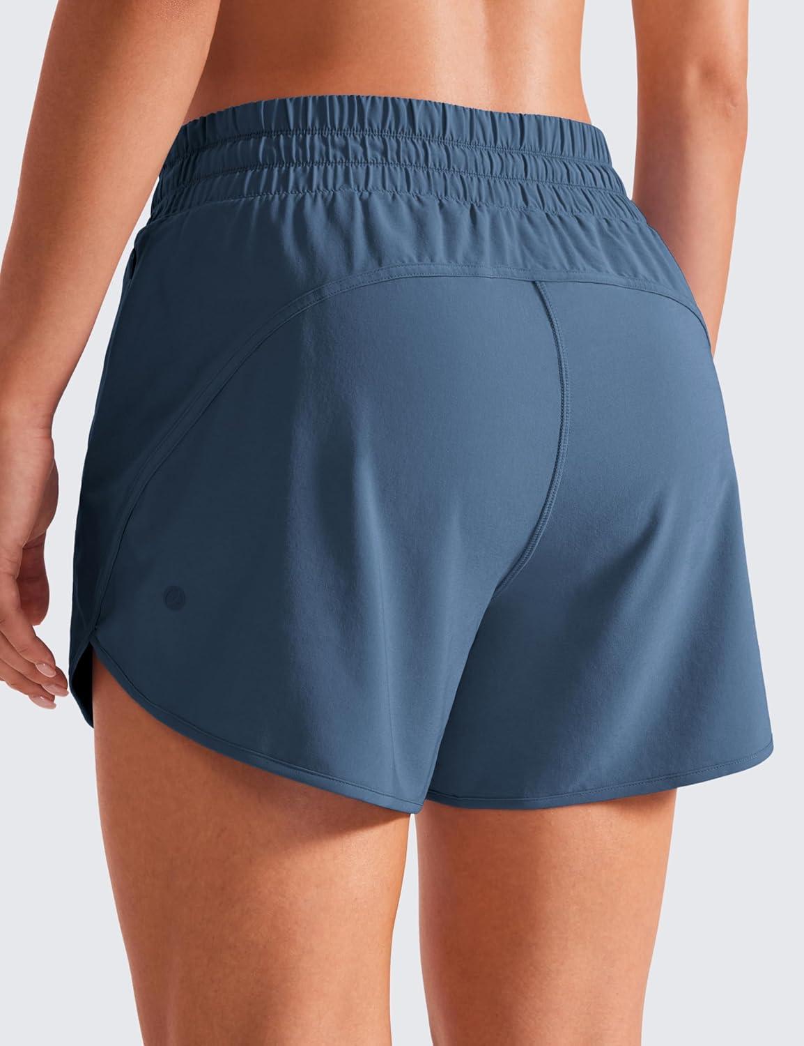 imageCRZ YOGA Dolphin Athletic Shorts for Women 5quot High Waisted Quick Dry for Running Workout Gym Track with Zip PocketStelindigo Blue