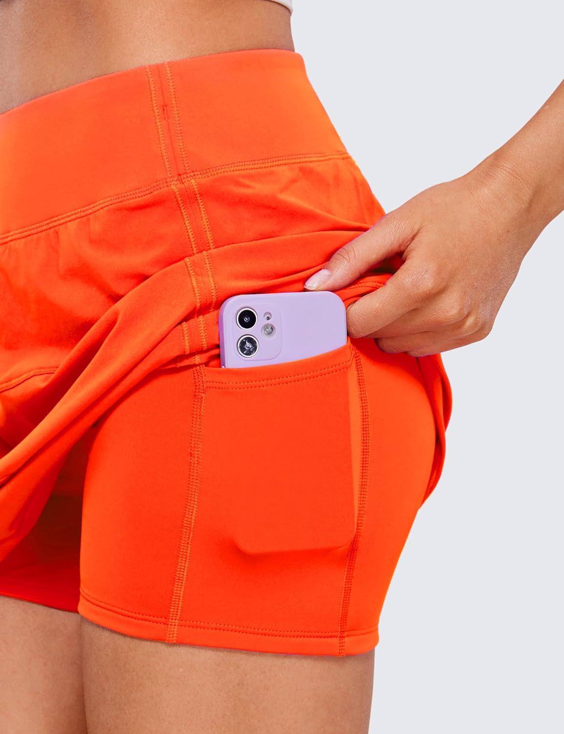 imageCRZ YOGA High Waisted A line Golf Skirts for Women Mini Lined Tennis Casual Work Skorts with 3 PocketsNeon Orange