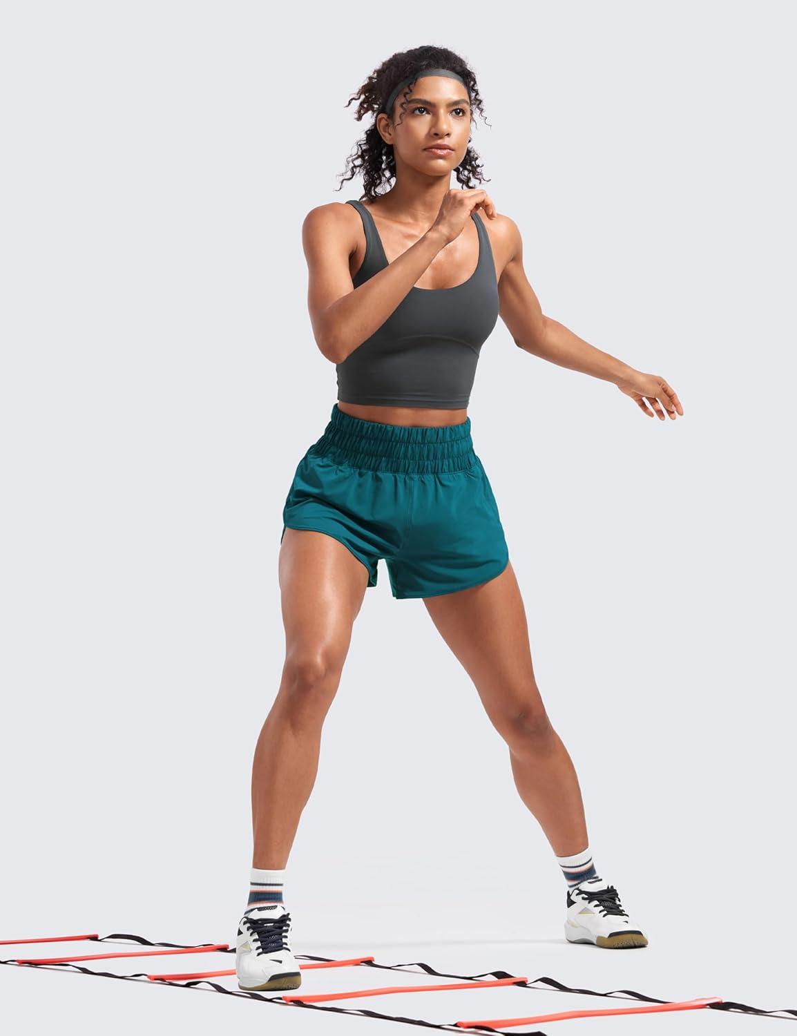 imageCRZ YOGA High Waisted Dolphin Running Shorts for Womens Mesh Liner for Gym Workout Athletic with Zipper PocketBorealis Green