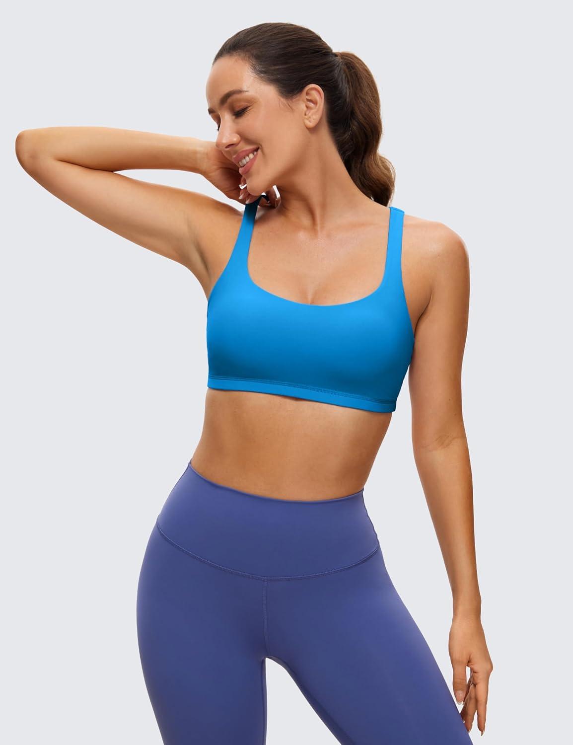 imageCRZ YOGA Womens Light Support Strappy Sports Bra Low Cut Wirefree Padded Yoga Cami Criss Cross BackMadagascar Blue