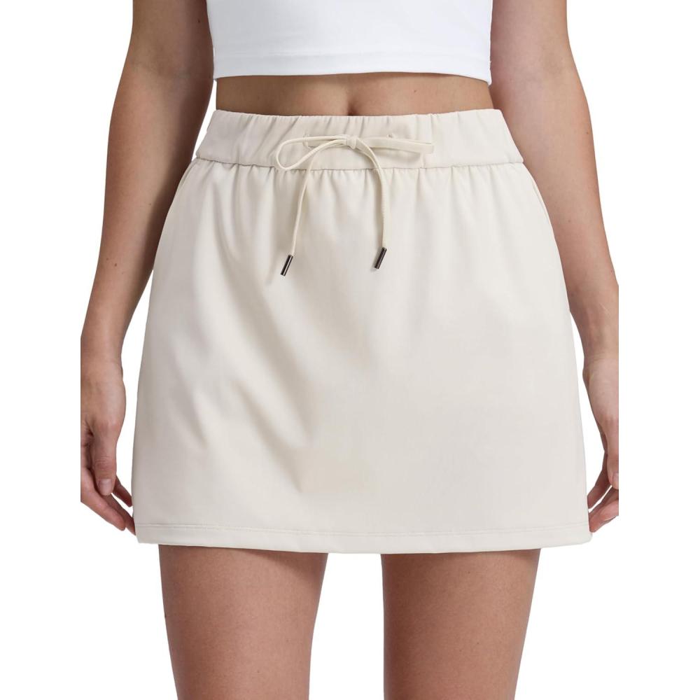 imageCRZ YOGA 4Way Stretch A Line Skirts for Women High Waitsted Mini Lined Tennis Work Drawstring Skort with PocketsMilky White
