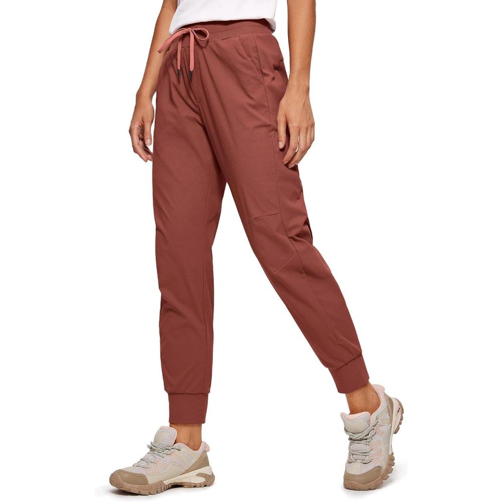 imageCRZ YOGA Athletic Joggers for Women 275quot Lightweight Travel Outdoor Hiking Pants with PocketsThe Cognac Brown