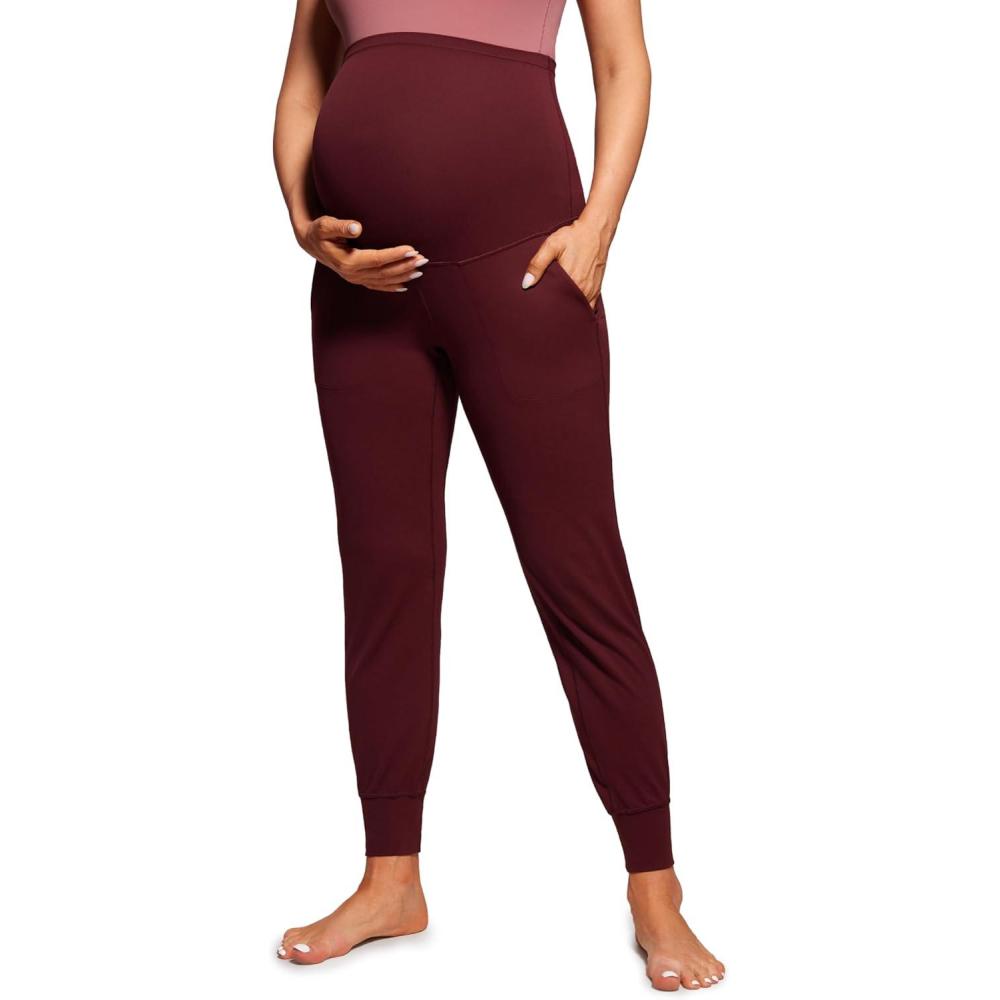 imageCRZ YOGA Butterluxe Maternity Joggers Pockets 27quot Workout Active Yoga Pregnancy Womens Pants Over The Belly SoftRed Merlot