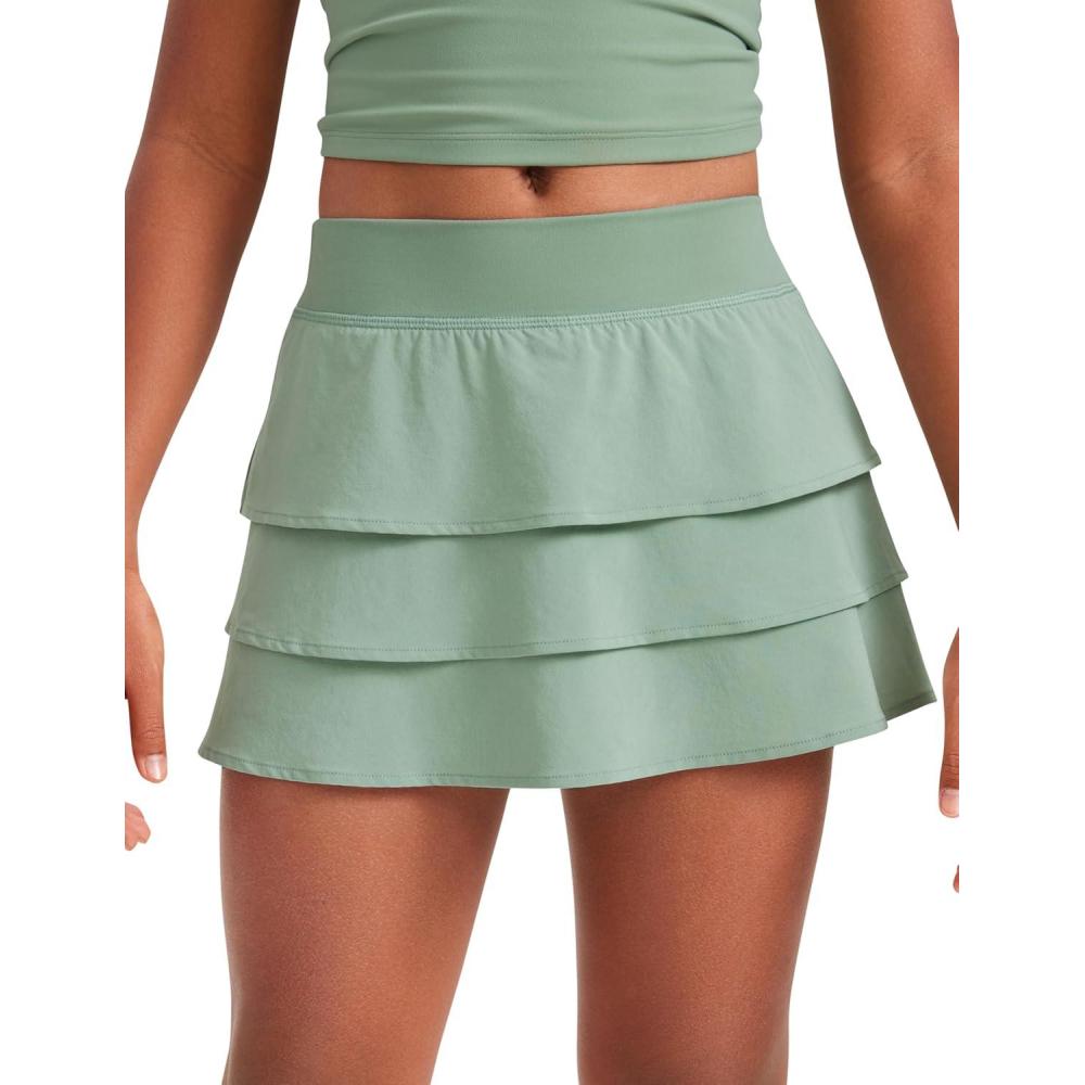 imageCRZ YOGA Girls FeatheryFit Soft Ruffle Athletic Skirts Tennis School Casual Skorts with Pockets Liner Kids TeenGreen Palm Court